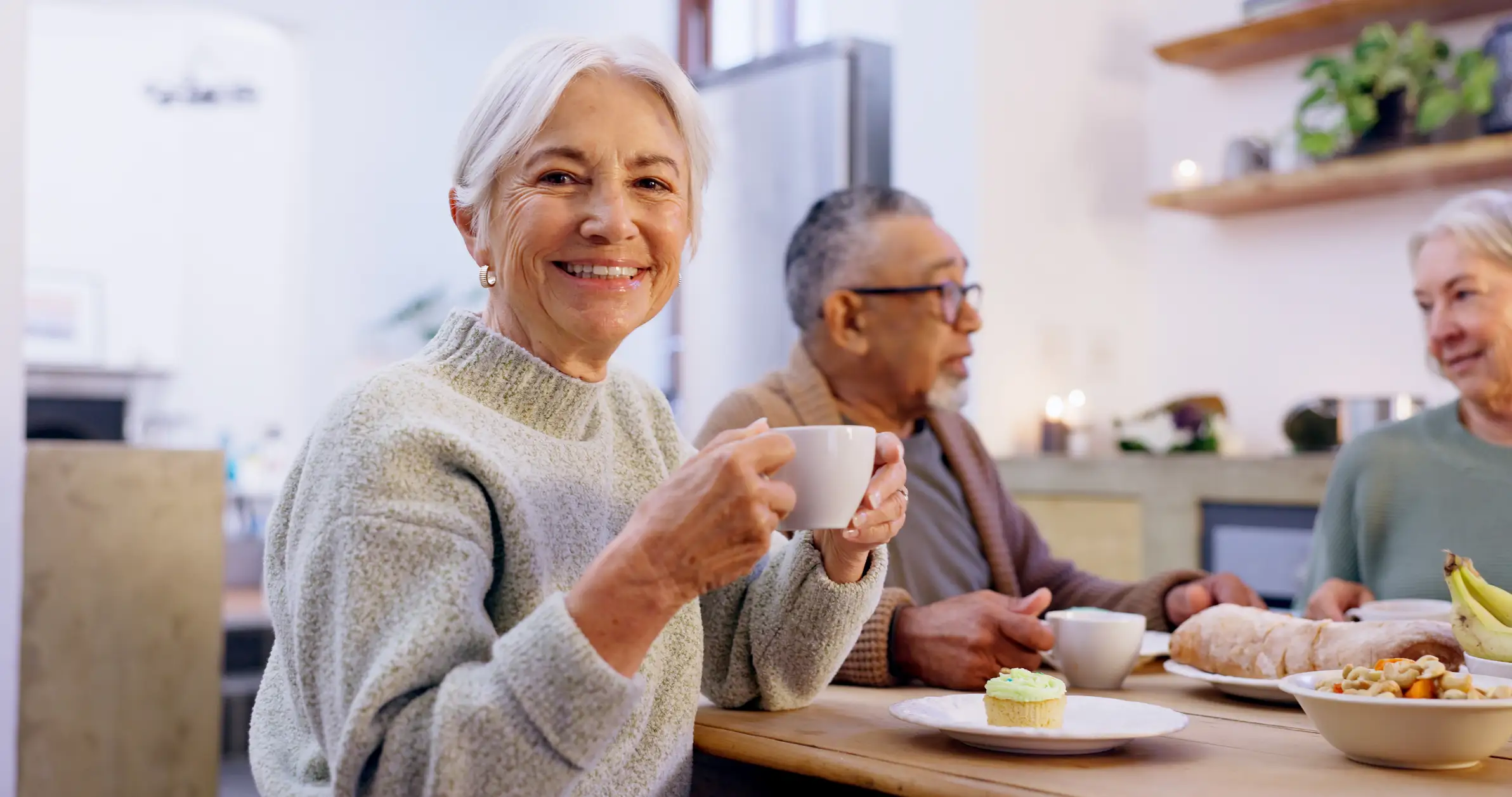 Senior woman enjoying coffee with her friends